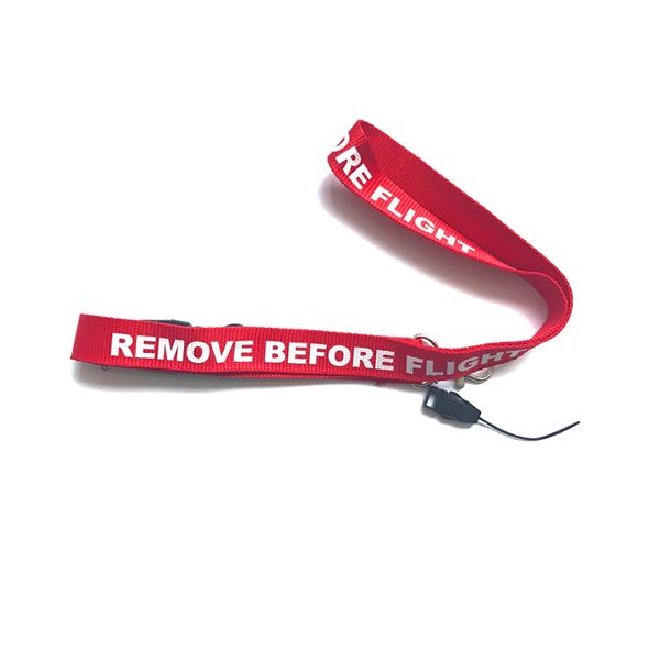 Šňůrka na krk REMOVE BEFORE FLIGHT tm. červená